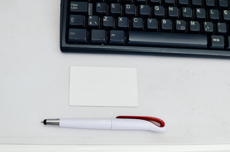 Mobile phone and computer keyboard on light table, communication technology background. Digital concept, gadgets support service, close up top view of electronic devicesの写真素材