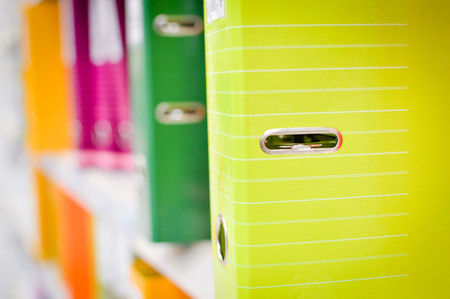 Close up on multicolored office folders on the bookshelf backgrounds.の写真素材