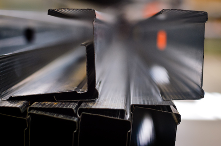 Close up of aluminium profile stacked steel background.の写真素材
