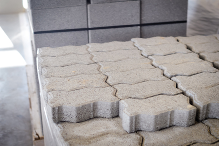Motion blur image of cement building blocks stacked piled in warehouse background, closeup fabric plant manufacture grey textured abstract surfaceの写真素材