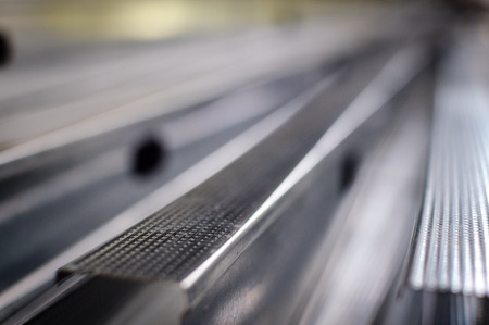 Close up of aluminium profile stacked steel background.