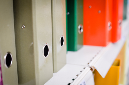 Closeup image of office shelves paperwork dossier binder background. Manage organization accountancy, financial bureaucracy, workplace guidelines, education university knowledge organizerの写真素材