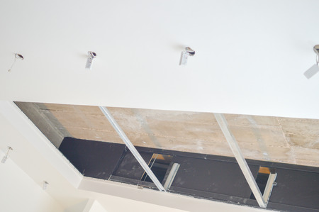 Electric sockets light works mounting and installation on plaster wall background. Professional...