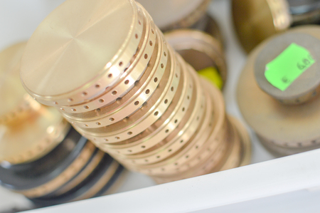 Gas plates spare parts for cooker, product shopping display background. Closeup on golden and gray shiny round shape elements of household applianceの写真素材