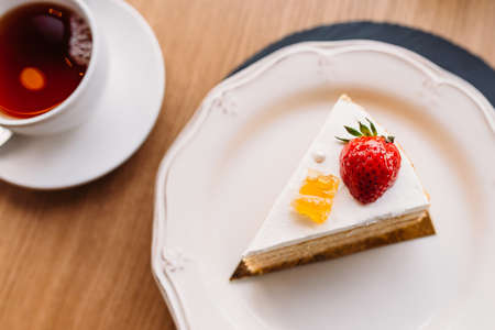 Piece of cake with a tea on the table.の写真素材