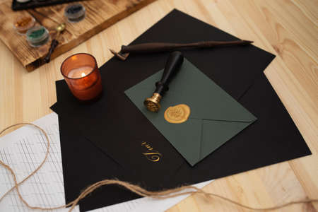 Calligraphy accessories, black paper and envelope lying on wooden tableの写真素材