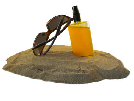 Sunglasses and sunoil on the beachの写真素材