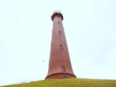 A lighthouse on a green hillの写真素材