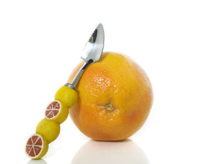 Grapefruit with a spoon on a white background の写真素材