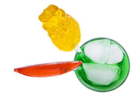 A green cocktail with decoration straws on a white backgroundの写真素材