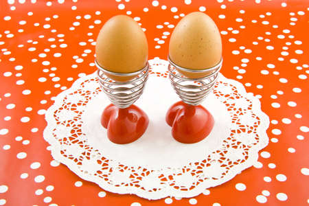 Two eggs in eggcups on a speckles background Two eggs in eggcups on a speckles background