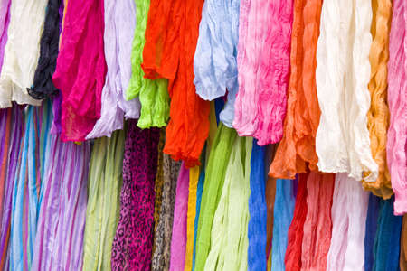 Lots of colorful shawls on a market placeの写真素材