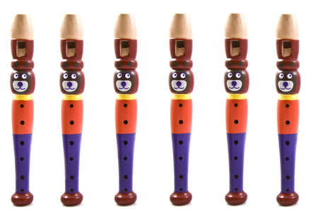 Six colorful bear flutes in a row isolated over whiteの写真素材