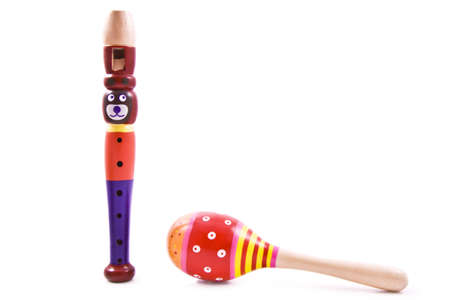 Bear flute and colorful rattle shaker isolated over whiteの写真素材