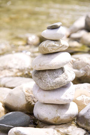 Pile of stones near a river in balanceの写真素材