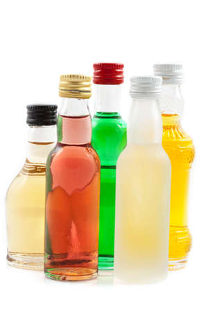 Different bottles with liquor isolated over whiteの写真素材