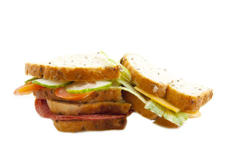 Several sandwiches with cheese and salami isolated over whiteの写真素材
