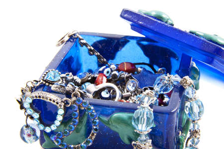 Blue jewel box with jewels isolated over whiteの写真素材