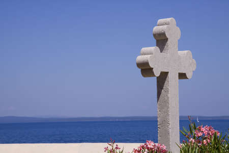Cross on graveyard with medeteranian sea on the backgroundの写真素材