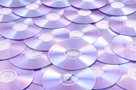 Lots of colorful discs on a pile for background useの写真素材