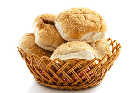 Bread in a basket isolated over whiteの写真素材