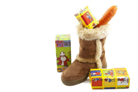 Boot with carrot and presents isolated over whiteの写真素材