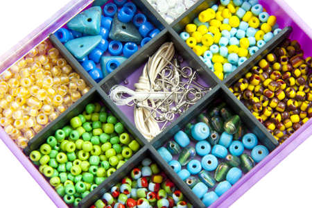Different kind of colorful beads close up on a white backgroundの写真素材
