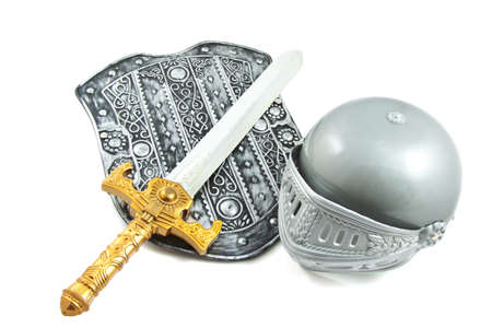 Old shield with sword and helmet isolated over whiteの写真素材