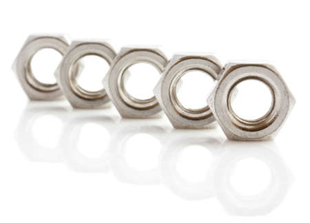 Stainless steal nuts in a row isolated over whiteの写真素材