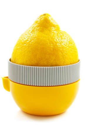 Lemon on juice press isolated over whiteの写真素材