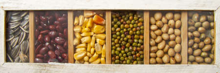 Handmade wooden box with lots of beansの写真素材