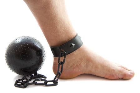 Chained foot with ball isolated over whiteの写真素材
