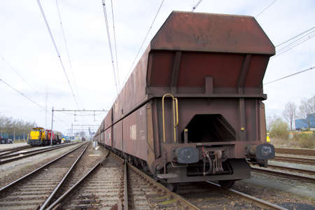Old rusty cargo train closeup on the railroad 