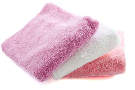 Three colorful towels on a white backgroundの写真素材