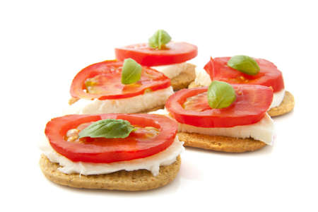 Toast with tomato cheese and basil isolated over whiteの写真素材