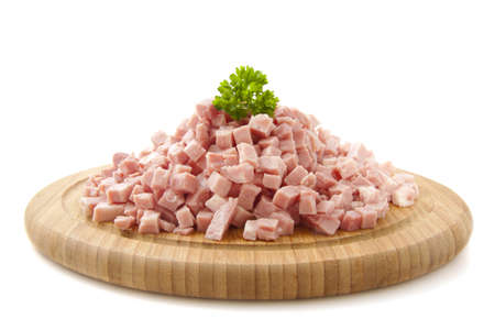 Pieces of ham on wooden plate isolated over whiteの写真素材
