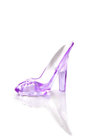 Beautiful pink glass high-heeled shoe isolated over whiteの写真素材