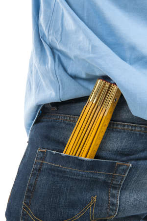 A ruler in blue jeans on white backgroundの写真素材