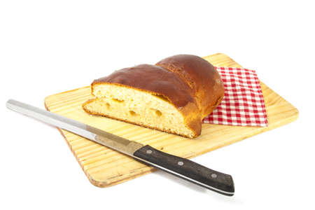 Sugarbread on a wooden board with knife and napkin isolated over white