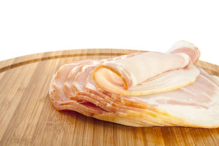 Fresh slices of pork on a wooden board for background useの写真素材