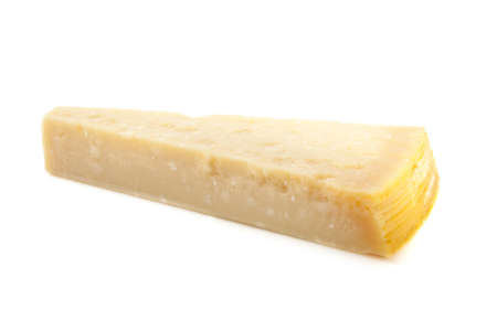 Nice piece of parmesan cheese isolated over whiteの写真素材