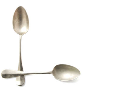 Two old vintage silver spoons isolated over whiteの写真素材