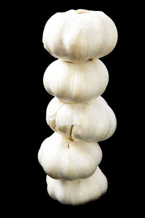 Pile of garlic isolated on a black backgroundの写真素材