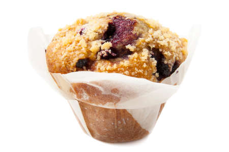 Blueberry muffin in baking paper isolated over whiteの写真素材
