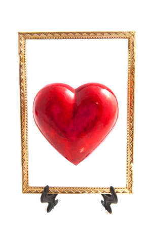 Red heart in golden frame isolated over whiteの写真素材