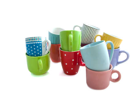 Colorful cups on a pile  isolated over whiteの写真素材