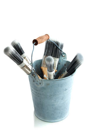 Paint brushes in bucket isolated over whiteの写真素材
