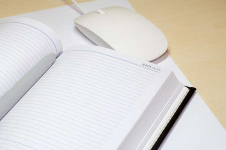memo pad and a computer mouse on the desk