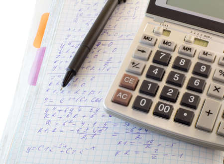 mathematical calculations and formulas, calculator and pen on a white background
