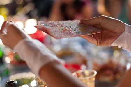 Congratulation and handing gift envelope in his handsの写真素材